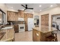 Functional kitchen featuring wood cabinets, granite countertops, and modern appliances at 1938 E Myrna Ln, Tempe, AZ 85284