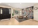 Inviting living room featuring neutral decor, a bay window and a full wall of built-in bookshelves at 1938 E Myrna Ln, Tempe, AZ 85284