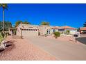 Desert-landscaped single-story home featuring an attached garage and well-maintained yard at 25236 S Lakeway Dr, Sun Lakes, AZ 85248