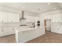 Bright kitchen with white cabinets, stainless steel appliances, and a spacious center island perfect for meal preparation at 25372 N 158Th Ct, Surprise, AZ 85387