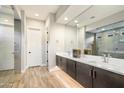 Modern primary bathroom with dual vanities, a large mirror, and a glass-enclosed shower at 2843 E Los Gatos Dr, Phoenix, AZ 85050