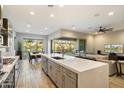 Open-concept kitchen flows into the living area, featuring a large island and stainless steel appliances at 2843 E Los Gatos Dr, Phoenix, AZ 85050