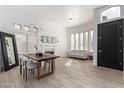 Bright dining room with a modern chandelier, fireplace, and large windows at 328 E Ivy St, Mesa, AZ 85201