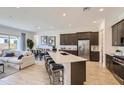 Modern kitchen with stainless steel appliances, a large island with bar seating, and ample cabinet space at 3794 E Terrel St, San Tan Valley, AZ 85143