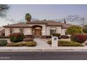 Charming single-story home with neutral paint, a tile roof, and lush landscaping at 3954 E Florian Ave, Mesa, AZ 85206