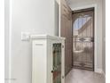 Open foyer with white display cabinet and door with security screen at 4202 E Broadway Rd # 211, Mesa, AZ 85206