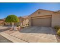 Single story home with desert landscaping, a two-car garage, and an arched entryway at 4202 E Broadway Rd # 211, Mesa, AZ 85206