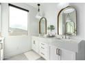 Bright bathroom with double sinks, gold-framed mirrors, marble countertops, and stylish light fixtures at 4226 E Marlene Dr, Gilbert, AZ 85296