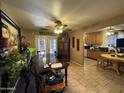 Open dining room with dark wood table, decor, tile flooring, and ceiling fan at 451 E Franklin Ave, Mesa, AZ 85204