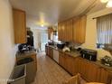 Functional kitchen featuring ample wooden cabinetry and essential appliances at 451 E Franklin Ave, Mesa, AZ 85204