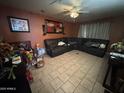 Spacious living room featuring tile floors and a cozy, large sectional sofa at 451 E Franklin Ave, Mesa, AZ 85204