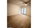 Bright and airy bedroom with wood floors and glass doors leading to outdoor area at 4765 W Mediterranean Dr, Glendale, AZ 85301