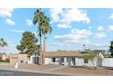 Well maintained single-story home with two palm trees in front and a low maintenance rock yard at 5232 E Everett Dr, Scottsdale, AZ 85254