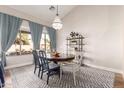 Elegant dining room features a stylish chandelier, large windows, and a decorative rug at 662 W Raven Dr, Chandler, AZ 85286