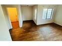 Bright living room featuring wood-look flooring and a large window at 6727 E Stacy St, Florence, AZ 85132