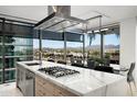 Modern kitchen with stainless steel appliances, marble countertops, and a scenic city view at 7180 E Kierland Blvd # 508, Scottsdale, AZ 85254