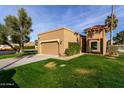 Well-maintained exterior with a green lawn, a two-car garage, and lush landscaping at 7318 E Palo Verde Dr # 7, Scottsdale, AZ 85250