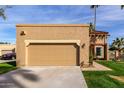 Spacious two-car garage with a well-kept lawn and desert landscaping at 7318 E Palo Verde Dr # 7, Scottsdale, AZ 85250