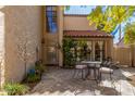 Private outdoor patio featuring an iron table with chairs, greenery, and secure access to the home at 11175 N 109Th Pl, Scottsdale, AZ 85259