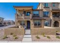 Beautiful two-story townhome showcasing a charming front patio, attractive desert landscaping and inviting curb appeal at 1255 N Arizona Ave # 1246, Chandler, AZ 85225