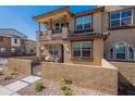 Charming two-story townhome featuring a cozy front patio with stylish wrought iron gate and desert landscaping at 1255 N Arizona Ave # 1246, Chandler, AZ 85225