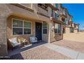 Inviting front porch showcasing seating area and wreath on the front door of this lovely townhome at 1255 N Arizona Ave # 1246, Chandler, AZ 85225