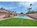 Backyard showcasing a refreshing swimming pool and covered patio area, perfect for outdoor living at 13014 N 23Rd Pl, Phoenix, AZ 85022