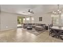 Spacious living room featuring tile floors, neutral colors, and a sliding glass door to the patio at 13225 W Rowel Rd, Peoria, AZ 85383