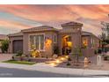 Charming single-story home with a tile roof, landscaped front yard, and walkway with inviting lighting at 1407 E Artemis Trl, San Tan Valley, AZ 85140