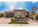 Charming single-story home with well-manicured front yard, desert landscaping, and neutral exterior paint at 1407 E Artemis Trl, San Tan Valley, AZ 85140