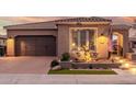 Charming home showcasing a brick driveway, desert landscaping, and a spacious two-car garage at 1407 E Artemis Trl, San Tan Valley, AZ 85140