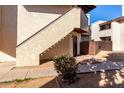 Exterior view of a two-story unit with a private fenced in area, stairs, and painted stucco walls at 16402 N 31St St # 102, Phoenix, AZ 85032