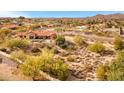 Aerial view of home in desert landscape, a pool, patio, and mountain views at 16522 E Glenbrook Blvd, Fountain Hills, AZ 85268
