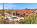 An amazing backyard featuring a pool, a spa, a covered patio, and artificial turf at 16522 E Glenbrook Blvd, Fountain Hills, AZ 85268
