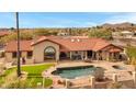 Backyard featuring a pool, spa, covered patio, artificial turf, and a mountain view at 16522 E Glenbrook Blvd, Fountain Hills, AZ 85268