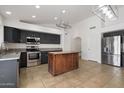 Modern kitchen features stainless steel appliances, dark cabinets, and a butcher block island at 17201 N Chance Dr, Surprise, AZ 85374