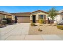 Single-story home with a brown garage door, desert landscaping, and a tiled roof at 20056 N 107Th Ln, Peoria, AZ 85373