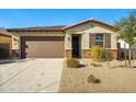 Single-story home with a brown garage door, desert landscaping, and a tiled roof at 20056 N 107Th Ln, Peoria, AZ 85373