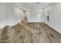 Open concept living room features tile floors and a window overlooking the yard at 2181 W Harmont Dr, Phoenix, AZ 85021