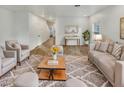 Bright living room with hardwood floors, neutral furniture, area rug, and decor at 2181 W Harmont Dr, Phoenix, AZ 85021