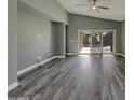 Spacious living room featuring hardwood floors, recessed lighting, high ceilings and sliding glass doors to the backyard at 2297 E Mews Rd, Gilbert, AZ 85298