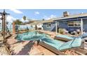 Backyard pool area with lounge seating and decorative tropical accents at 2505 E Hampton Ave, Mesa, AZ 85204