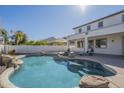 Lovely backyard pool with rock accents, sun loungers, and covered patio, an entertainer's delight at 2506 E Bridgeport Pkwy, Gilbert, AZ 85295
