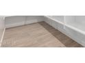 Well-lit closet space with shelving and sleek wood-look tile flooring at 25393 N 158Th Ct, Surprise, AZ 85387
