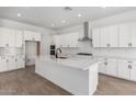 A spacious kitchen featuring white cabinets, a large island, and stainless steel appliances at 25393 N 158Th Ct, Surprise, AZ 85387