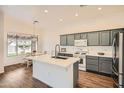 Modern kitchen featuring an island, stainless steel appliances, and stylish cabinetry at 2730 W Via Calabria St, Phoenix, AZ 85086