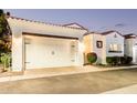 Single-story stucco home with red tile roof, arched windows, manicured shrubs, and a two-car garage at 2777 W Queen Creek Rd # 9, Chandler, AZ 85248