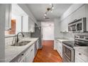 This bright kitchen features stainless steel appliances, marble countertops, and seamless transition to the living area at 2801 E Sylvia St, Phoenix, AZ 85032