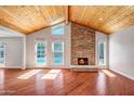 The living room has a stone fireplace, wood ceiling, windows and glass doors to the pool at 2801 E Sylvia St, Phoenix, AZ 85032