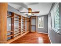The primary suite includes custom built-in shelves, hardwood floors, and a ceiling fan at 2801 E Sylvia St, Phoenix, AZ 85032